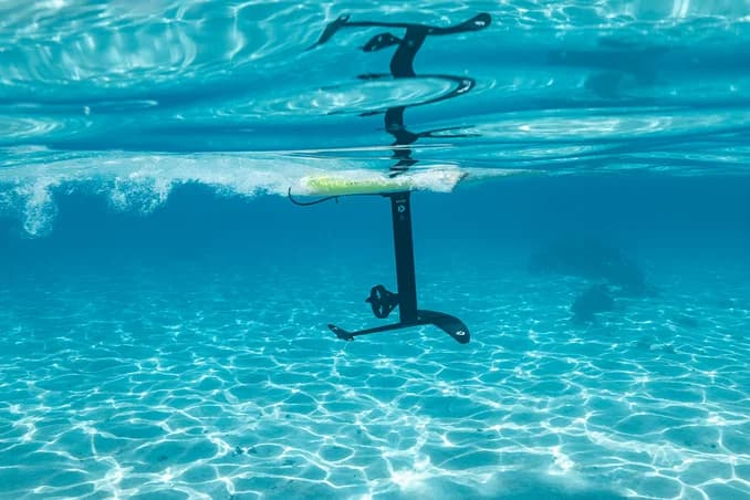 Two riders cruising over turquoise reef water